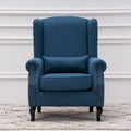 Fauteuil capitonné à oreilles avec clous de tapissier