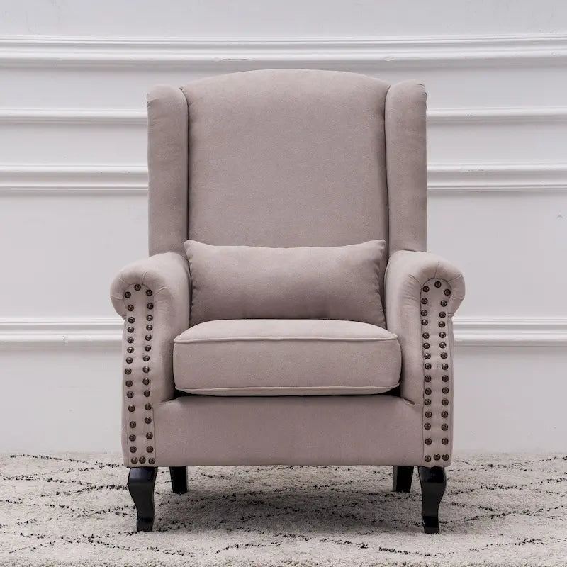 Fauteuil capitonné à oreilles avec clous de tapissier