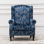 Fauteuil capitonné à oreilles avec clous de tapissier