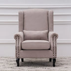 Fauteuil capitonné à oreilles avec clous de tapissier