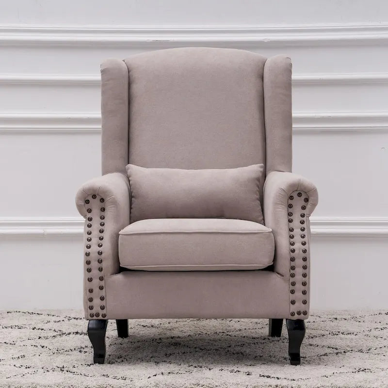 Fauteuil capitonné à oreilles avec clous de tapissier