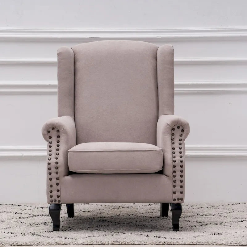 Fauteuil capitonné à oreilles avec clous de tapissier