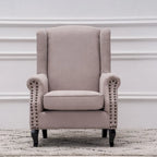 Fauteuil capitonné à oreilles avec clous de tapissier