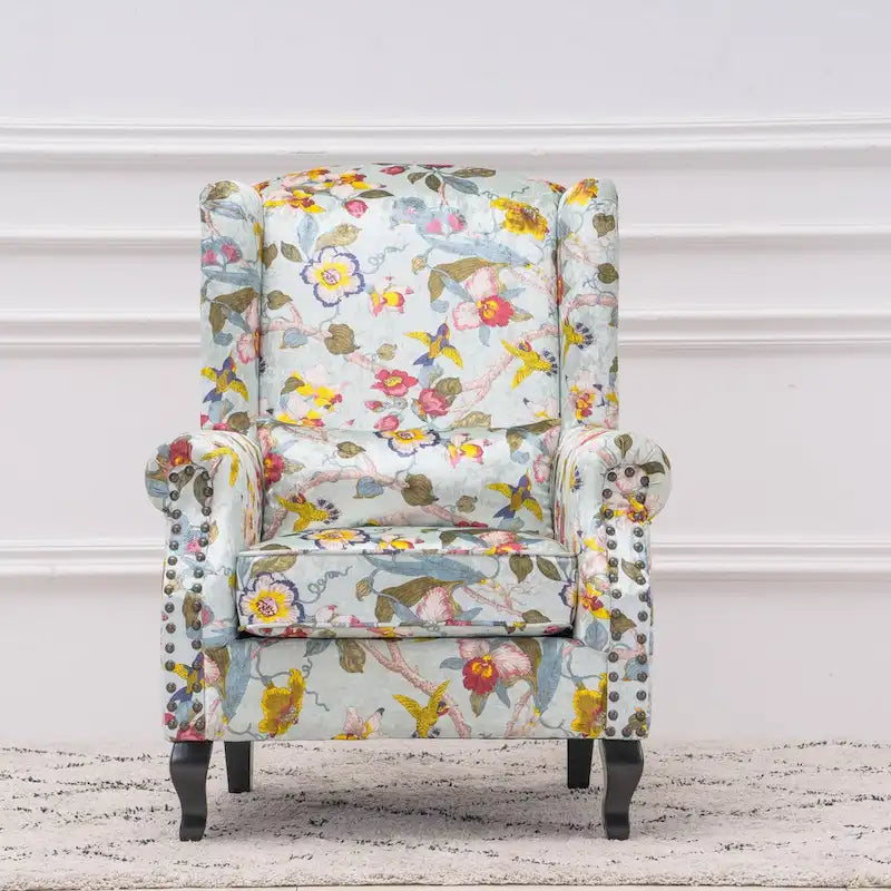 Fauteuil capitonné à oreilles avec clous de tapissier