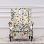 Fauteuil capitonné à oreilles avec clous de tapissier