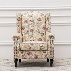 Fauteuil capitonné à oreilles avec clous de tapissier