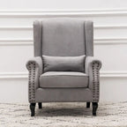 Fauteuil capitonné à oreilles avec clous de tapissier