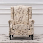 Fauteuil capitonné à oreilles avec clous de tapissier