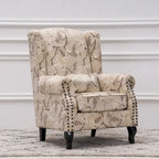 Fauteuil capitonné à oreilles avec clous de tapissier