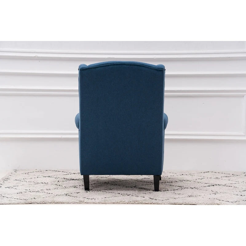 Fauteuil capitonné à oreilles avec clous de tapissier