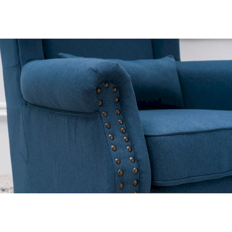 Fauteuil capitonné à oreilles avec clous de tapissier