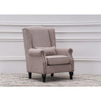 Fauteuil capitonné à oreilles avec clous de tapissier