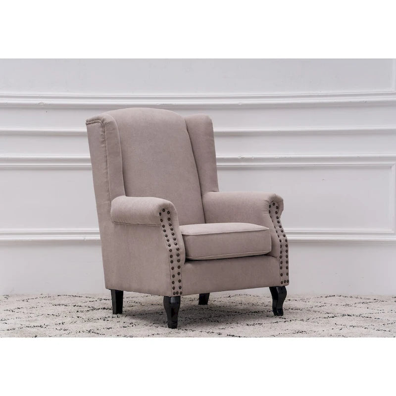 Fauteuil capitonné à oreilles avec clous de tapissier