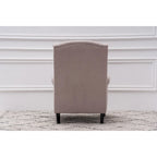 Fauteuil capitonné à oreilles avec clous de tapissier