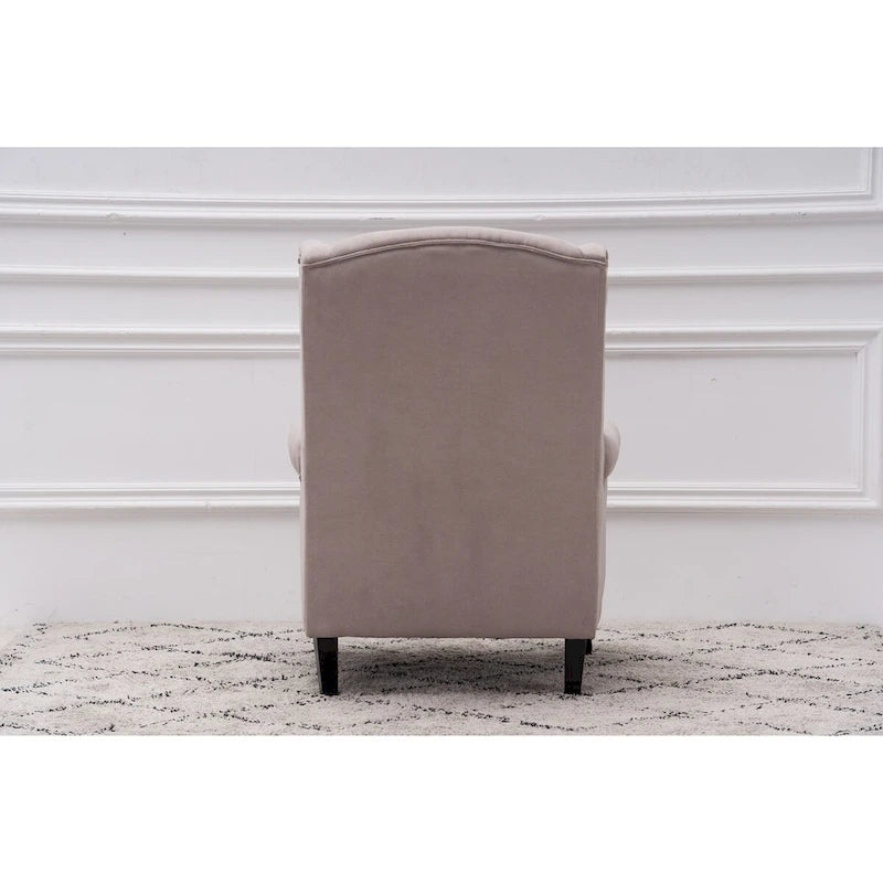 Fauteuil capitonné à oreilles avec clous de tapissier